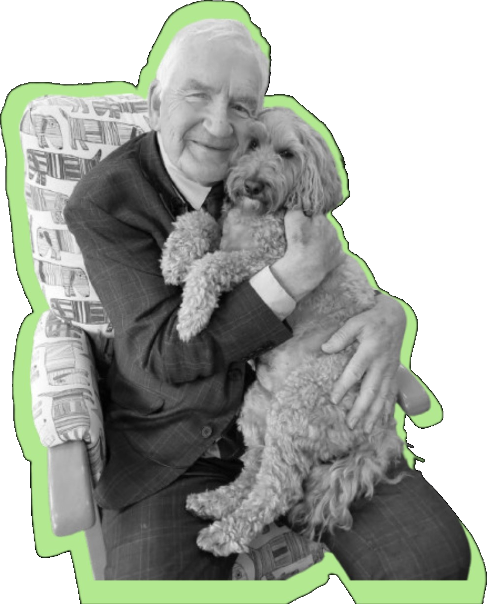 An older man hugging his dog